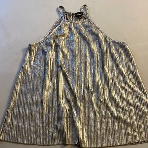 Shiny silver high neck top. Loose flow fitting.